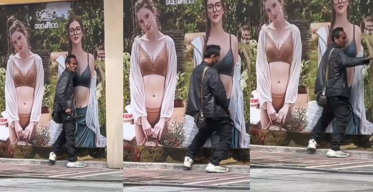 这是真饿急眼了 大街上一男子对广告牌竟然行不雅之事 大叔是多久没碰过女人!
