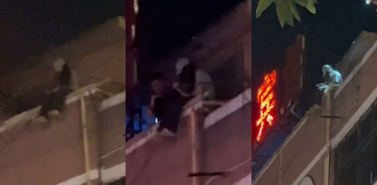 广西玉林清宁路宾馆男子危坐楼顶 消防全力救援 生命可贵莫想不开